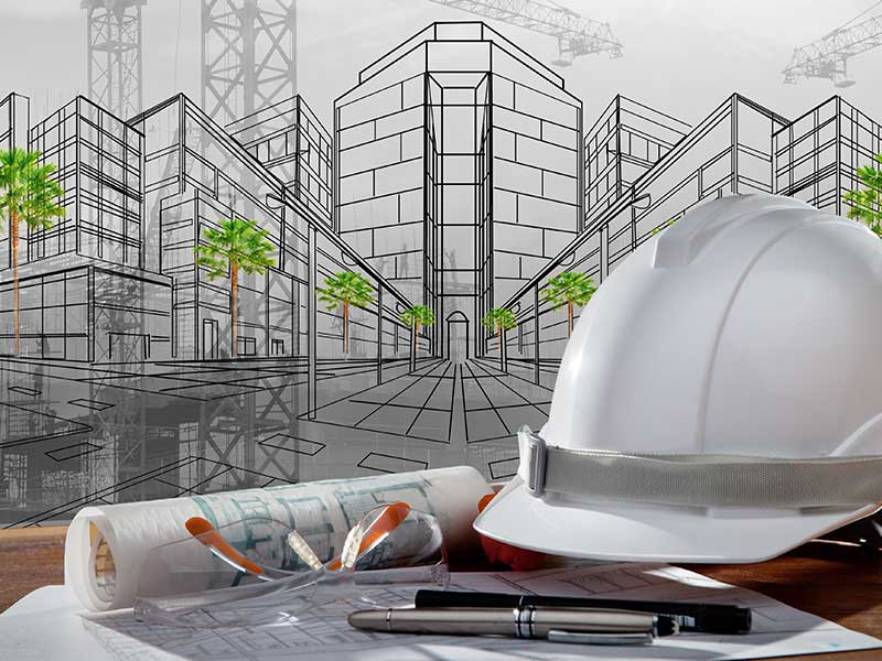 Building engineer hat and construction documents with illustration of building in background 