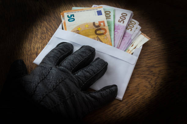 Illegal Cash Payment Hand in a Black Glove Handing Over an Envelope with a Bribe or Dirty Money money laundering euro stock pictures, royalty-free photos & images